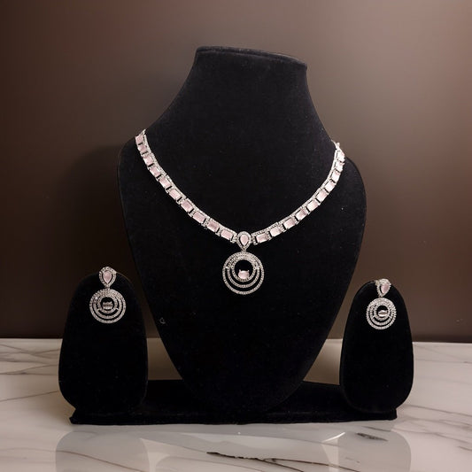 Add a touch of sparkle to your neckline with our American Diamond Crystal Silver Plated Stone Necklace. This elegant piece features sparkling crystals set in a silver-plated setting for a glamorous look. The adjustable chain ensures a perfect fit, making it suitable for all necklines.