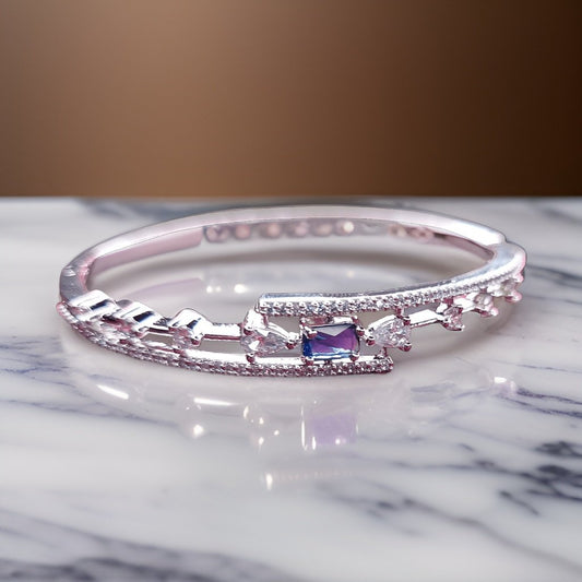 Make a statement with our Aura Blue Diamond Look Bracelet. Crafted with attention to detail, this bracelet features a captivating blue diamond-like design that exudes elegance. The adjustable clasp ensures a comfortable fit, making it suitable for everyday wear or special occasions.