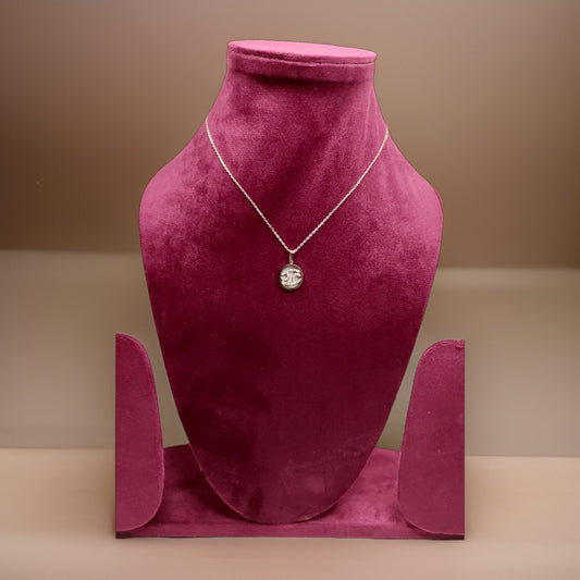 Add a touch of vintage charm to your look with our Coin Pendant. This stylish piece features a coin-inspired design that adds a timeless appeal to any ensemble. The adjustable chain ensures a comfortable fit, making it suitable for all necklines.