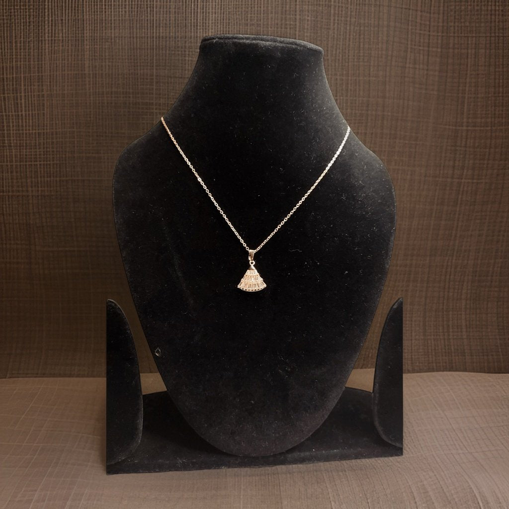 Make a statement with our Fan Pendant. This unique piece features a fan-shaped pendant that adds a touch of intrigue to any ensemble. The adjustable chain ensures a perfect fit, making it suitable for all necklines.