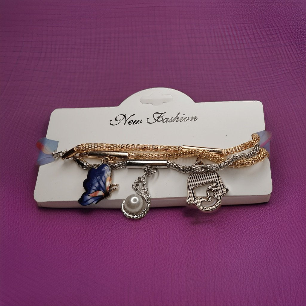 Make a style statement with our Three Icon Bracelet. Featuring three iconic symbols, this bracelet adds a touch of personality to any ensemble. The adjustable chain ensures a perfect fit, making it suitable for all wrist sizes.